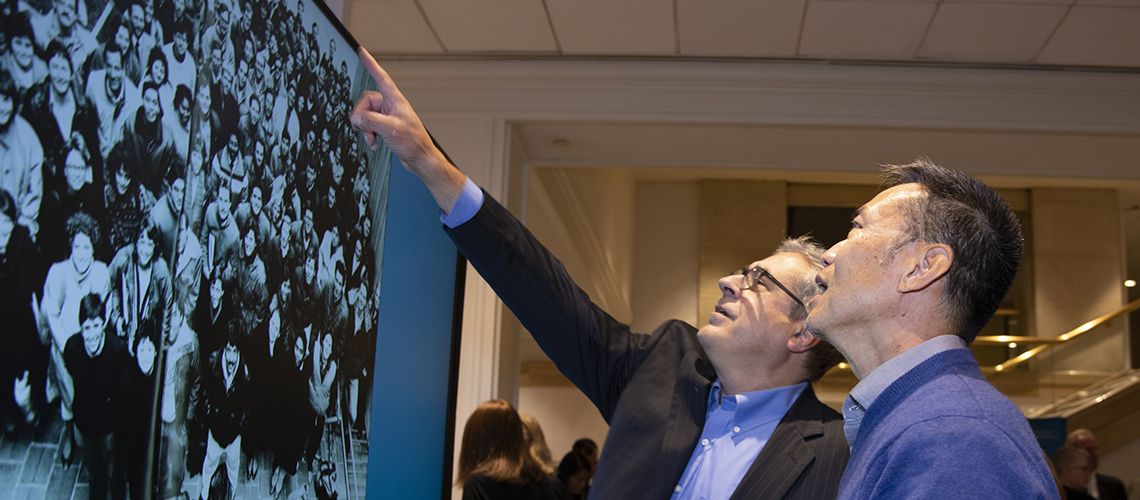 Alums viewing an image at a Reunion Event